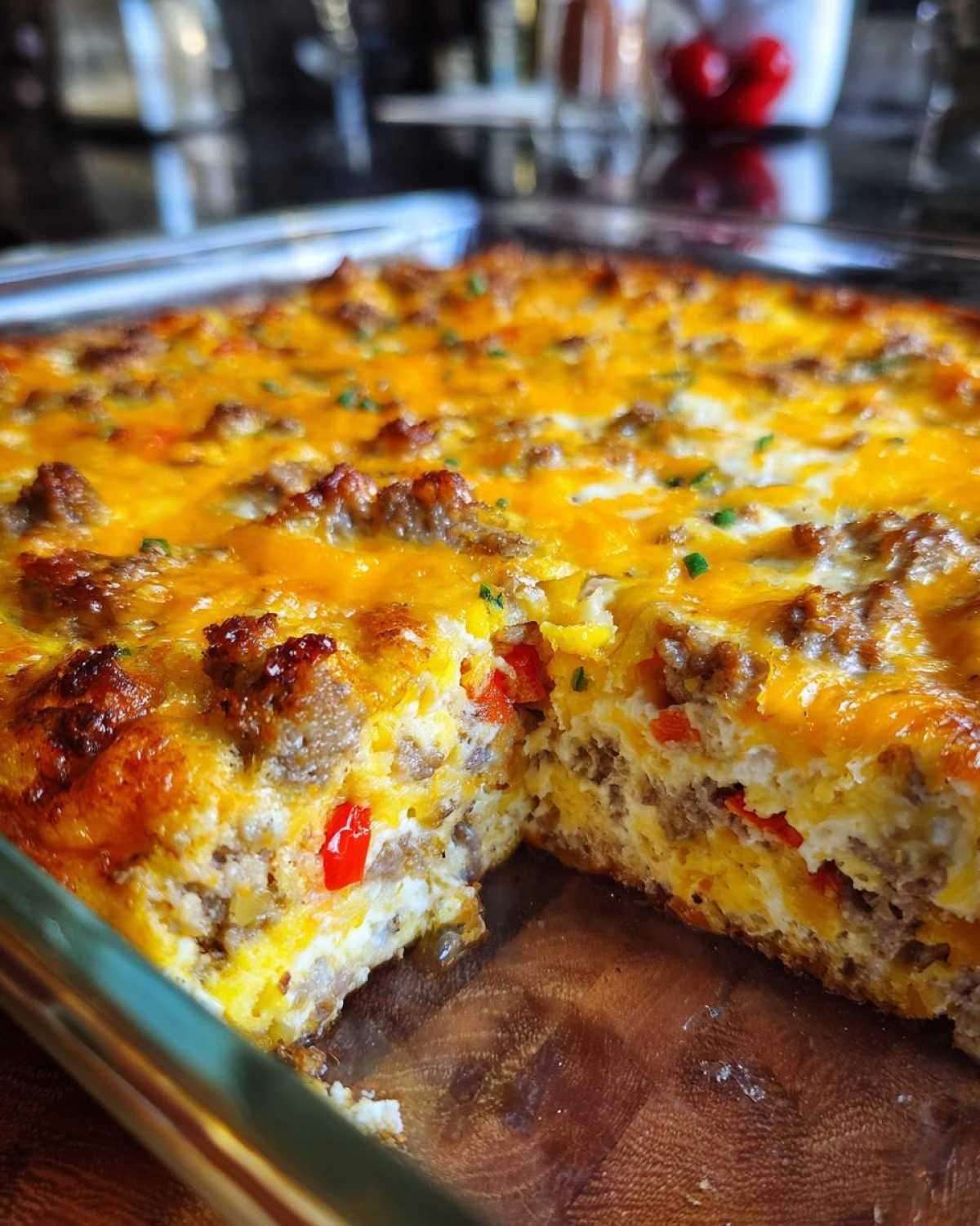 A freshly baked breakfast casserole with sausage, cheese, and peppers in a glass baking dish. Perfect breakfast casserole recipe.