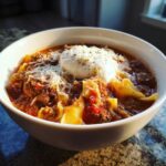 A delicious bowl of crockpot lasagna soup topped with ricotta and parmesan cheese.