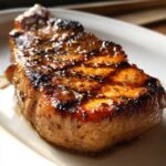 Close-up of a glazed pork chop, showcasing the delicious marinade for pork chops.