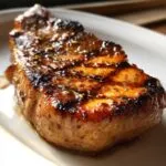 Close-up of a glazed pork chop, showcasing the delicious marinade for pork chops.