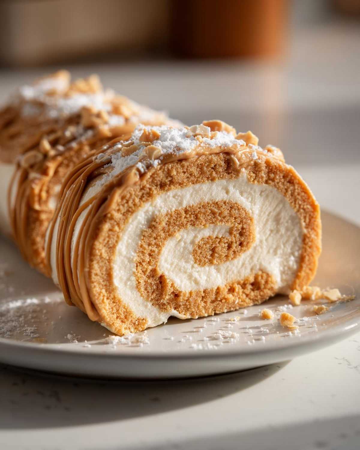 A slice of creamy potato candy roll dusted with powdered sugar and chopped nuts.