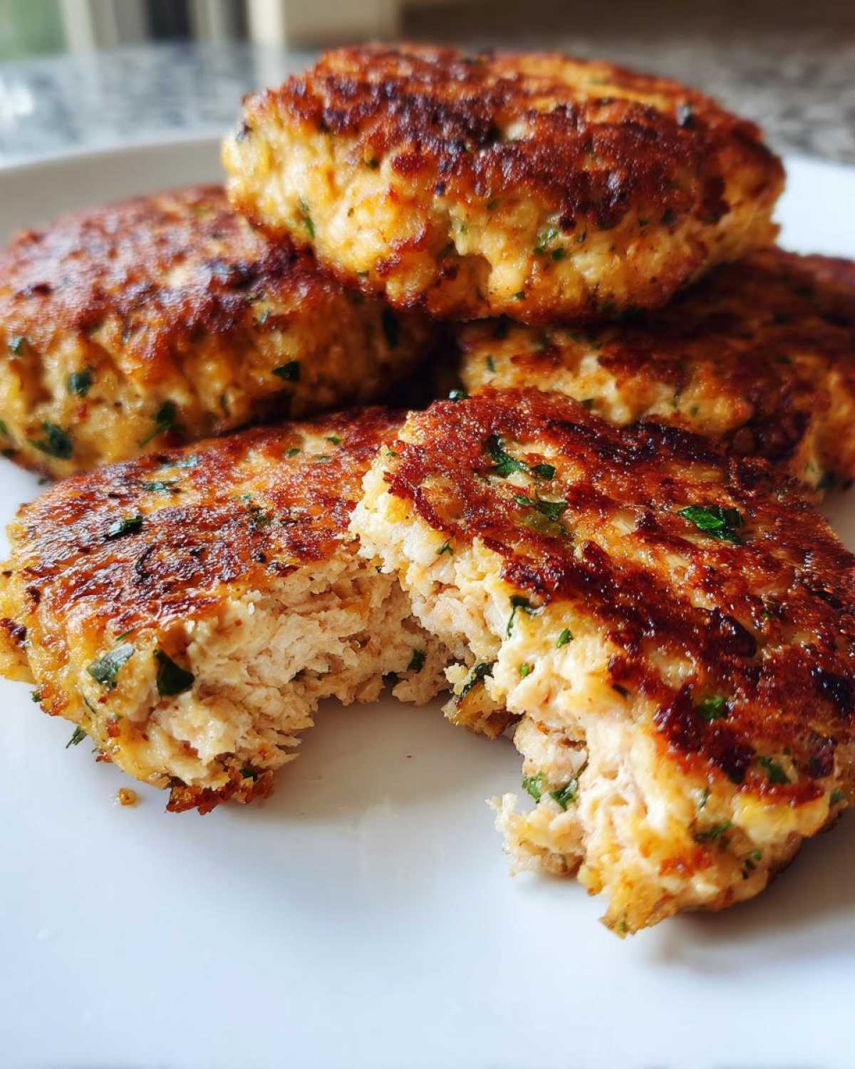 Close-up of tuna patties air fryer recipe, showing a patty broken open to reveal the inside texture.