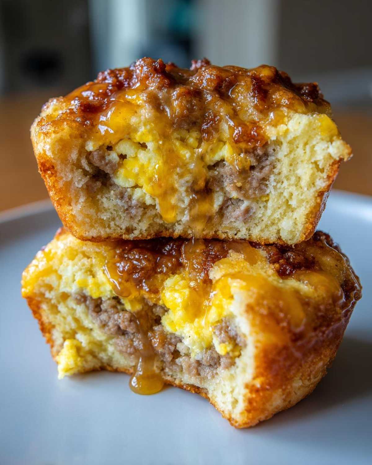 Close-up of two McGriddle muffins stacked, revealing a filling of sausage, scrambled egg, and syrup.