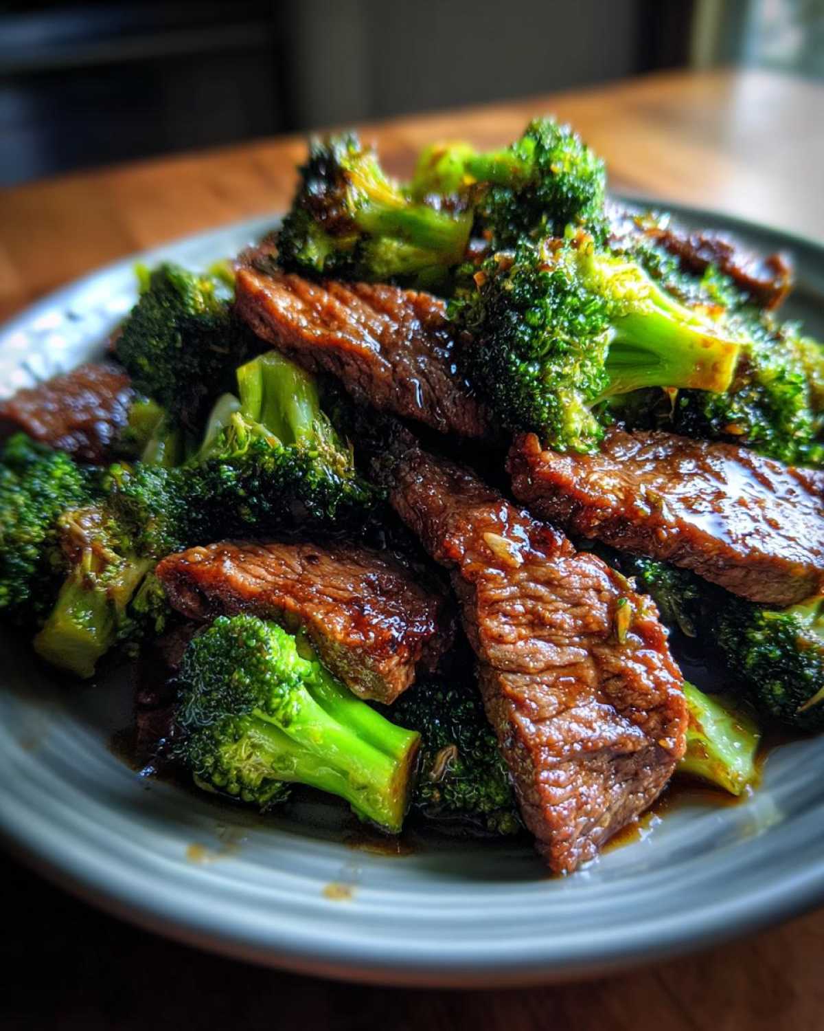 Close-up of tender slices of beef and vibrant broccoli florets coated in a glossy sauce, showcasing the 30-minute beef and broccoli.