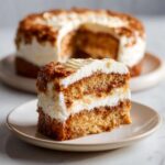 A close-up of a slice of Neiman Marcus cake with rich frosting and moist layers.