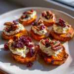 Crispy sweet potato rounds topped with creamy goat cheese, dried cranberries, and pecans.