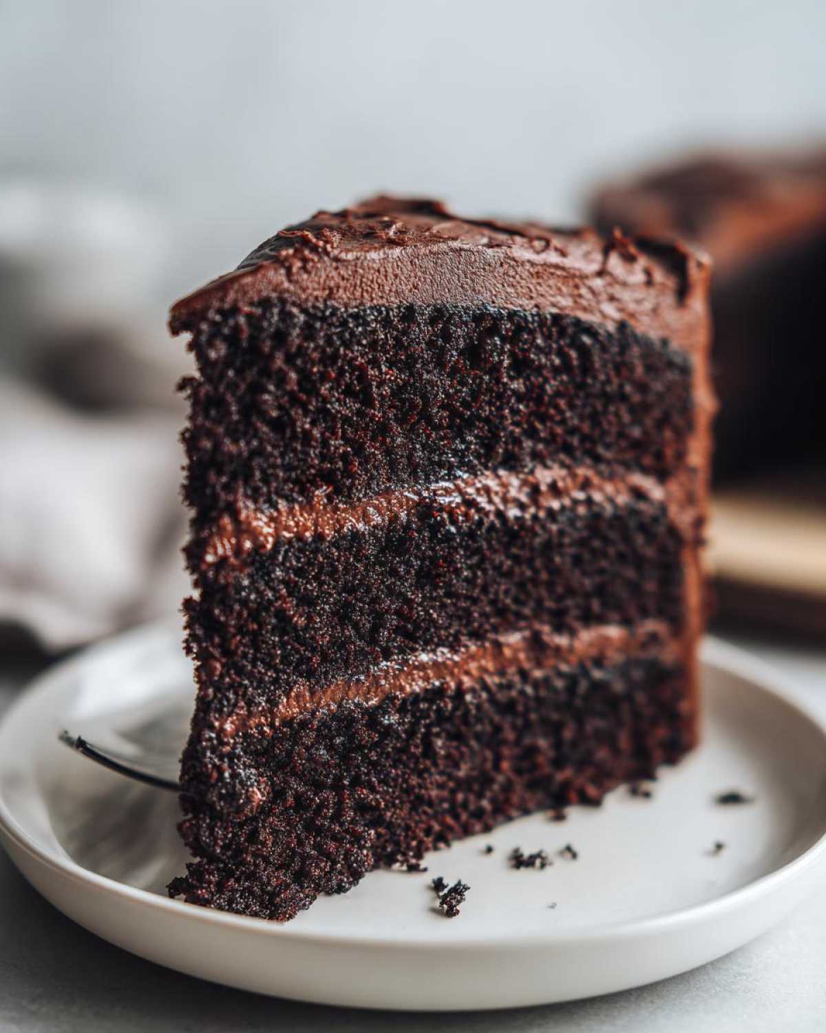 A moist slice of black velvet Halloween cake with rich chocolate frosting and layers.