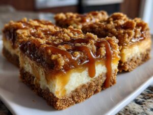Close-up of delicious caramel apple cheesecake bars drizzled with caramel sauce.