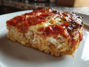 A slice of high-protein pizza cottage cheese bake with pepperoni and melted cheese.