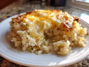 A serving of french onion butter rice topped with golden, melted, and slightly browned cheese.