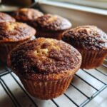 Close-up of freshly baked cinnamon sugar french toast muffins cooling on a wire rack.