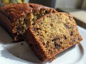 Close-up of a slice of moist sugar free banana bread showing a tender crumb and chocolate chips.