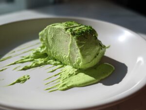 A thick serving of food covered and surrounded by bright green cilantro lime sauce, artfully plated.