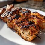 Close-up of perfectly grilled ranch garlic parmesan chicken skewers showing char marks and seasoning.